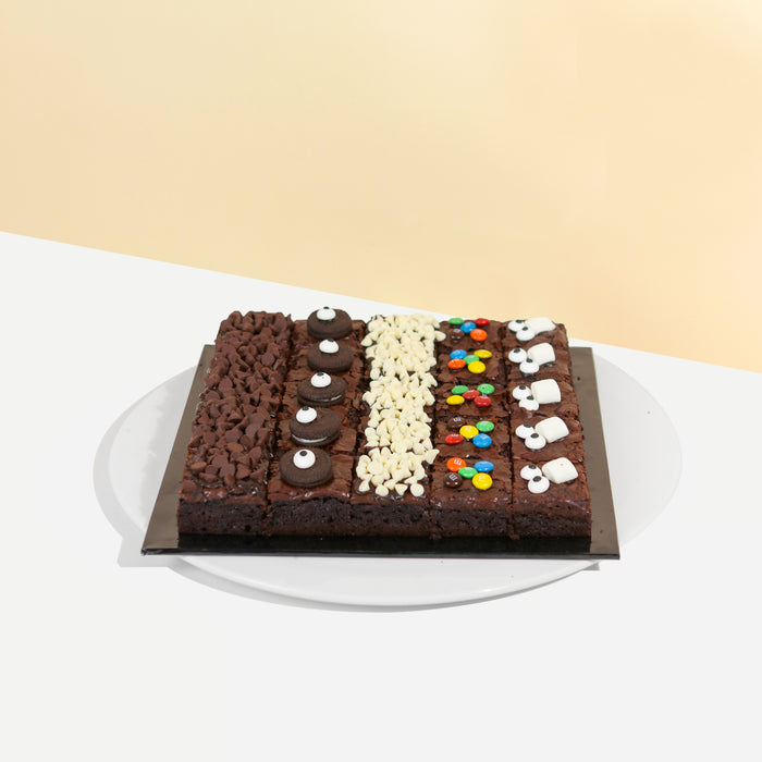 Bite sized brownies with dark chocolate chips, oreos, white chocolate chips, M&Ms and marshmallows as toppings