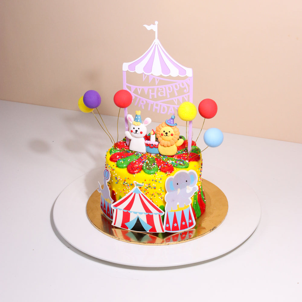 Circus themed cake with fondant rabbit and lion, with balloons