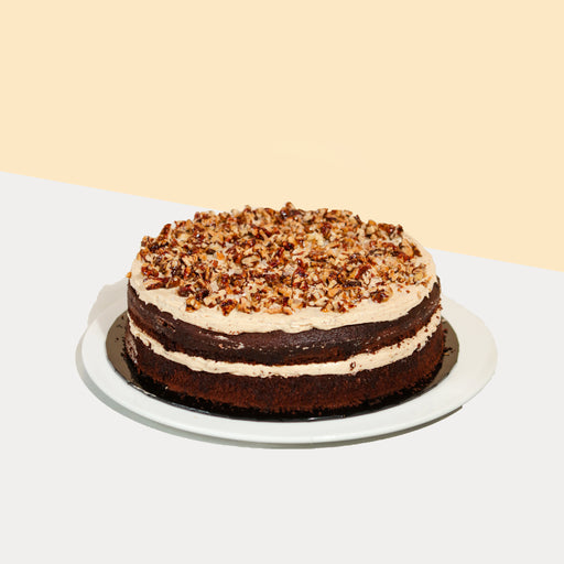 Chocolate cake sandwiched with salted caramel sauce and toasted pecans