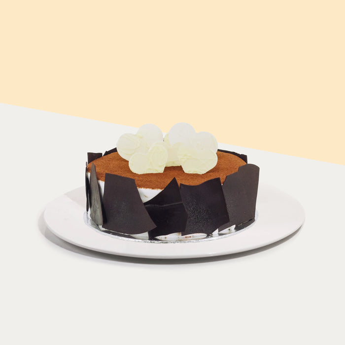 Tiramisu cake with chocolate shards, and heart shaped white chocolate on top