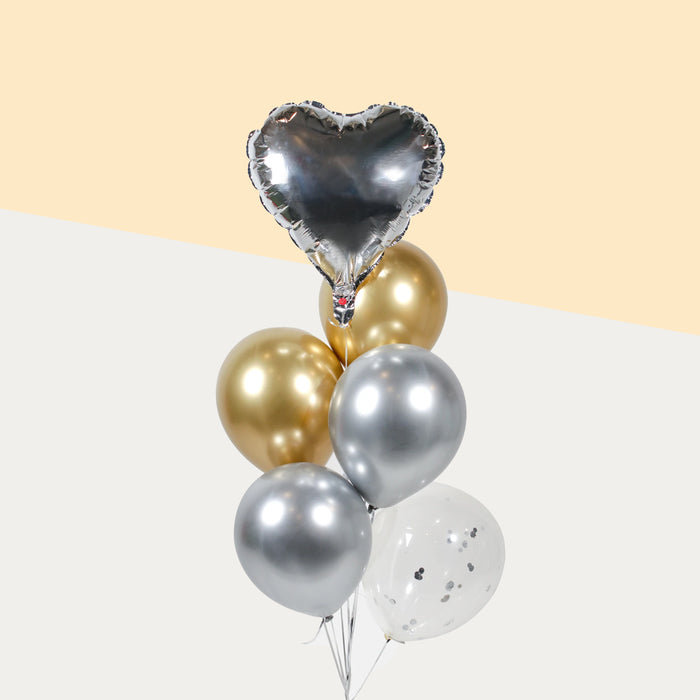 Silver themed balloons, with a silver foil heart, confetti, metallic gold and silver balloons