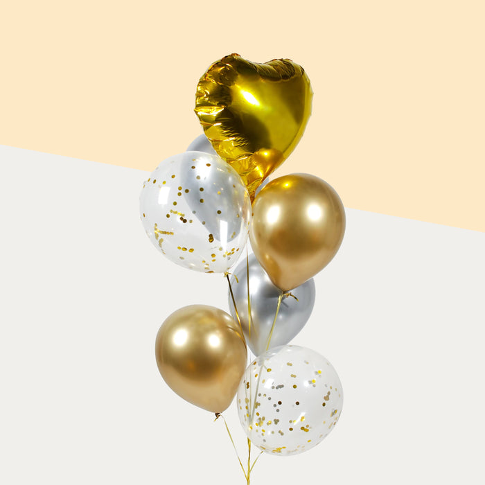 Gold themed balloons, with a gold foil heart, confetti, metallic gold and silver balloons