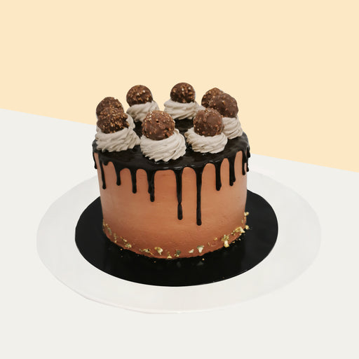 Hazelnut cake with Nutella cream, topped with Ferrero Rocher balls