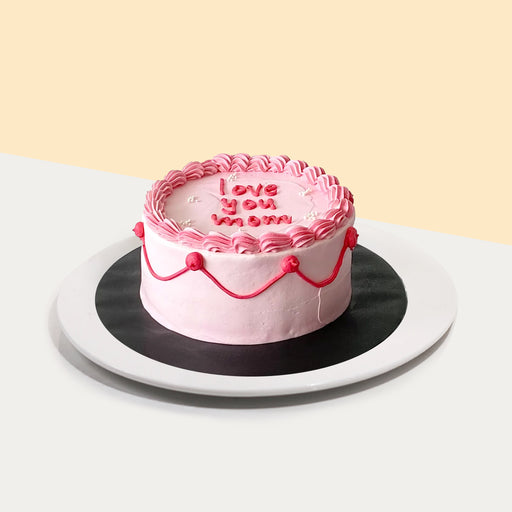 Pink vintage cake with 'love you mom' written on the cake