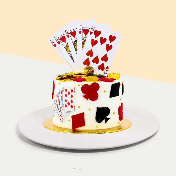 Poker themed cake with playing cards and poker related pieces