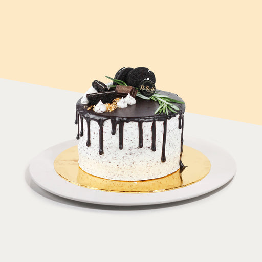Chocolate pepermint cake, topped with chocolate glaze, Oreos, Hershey Kisses and rosemary