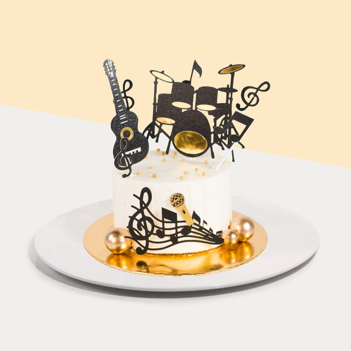 Music themed buttercream cake with 2d printed guitar and drums