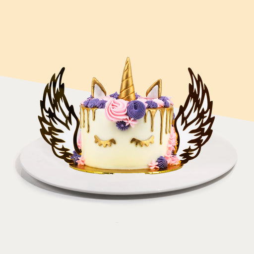 Royal unicorn cake with 2d printed wings, adorned with purple and pink buttercream