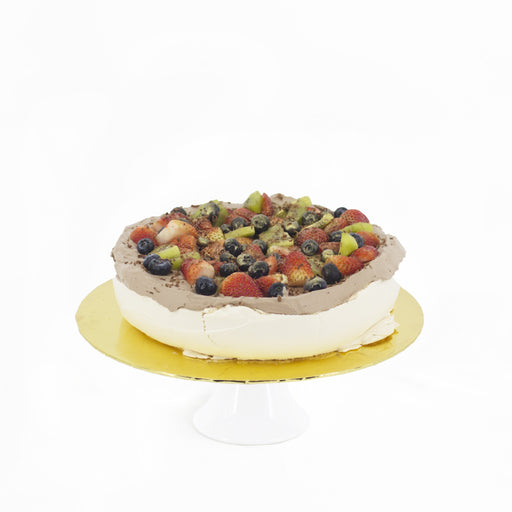Pavlova with non-dairy chocolate cream topped with fresh fruits