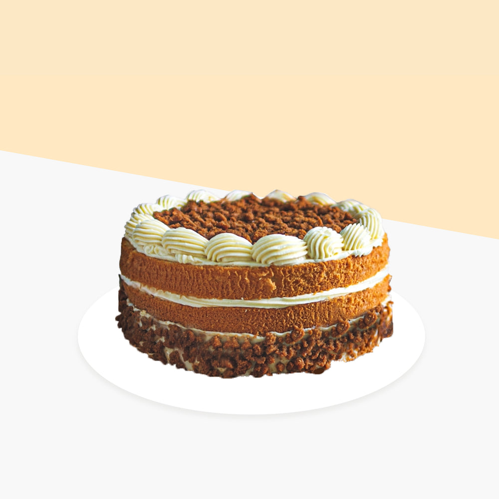 Buttercream cake with cream cheese, topped with lotus biscoff chunks
