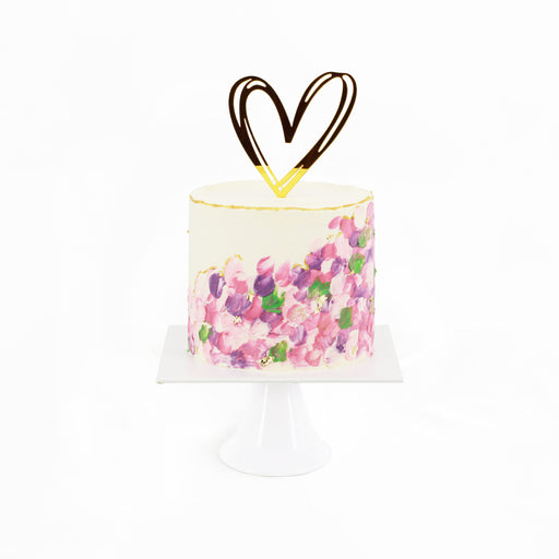 White buttercream frosted cake with Spring flowers painted on the side